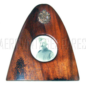 This mahogany propeller tip includes a photo of a named RFC corporal, G. N. Moore.  It also includes an original RFC cap badge affixed to the top.